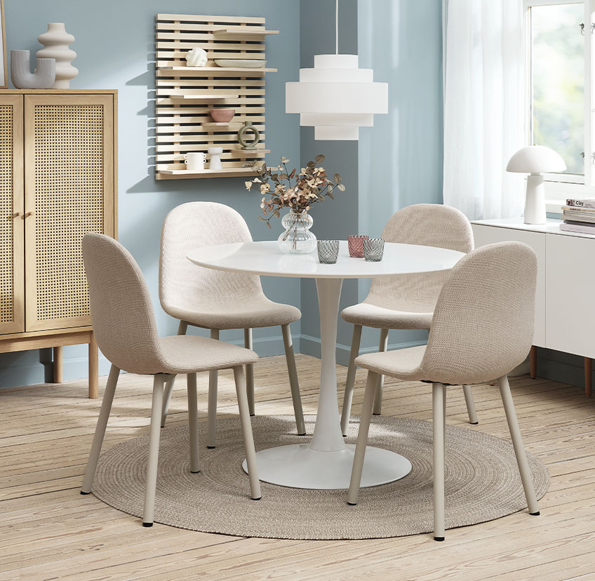 Світло-бежеві обідні стільці та круглий обідній стіл білого кольору