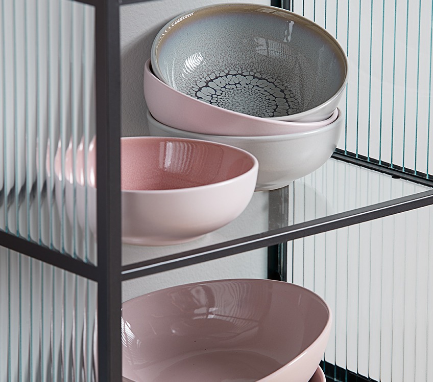 Ceramic bowls in a glass shelf 