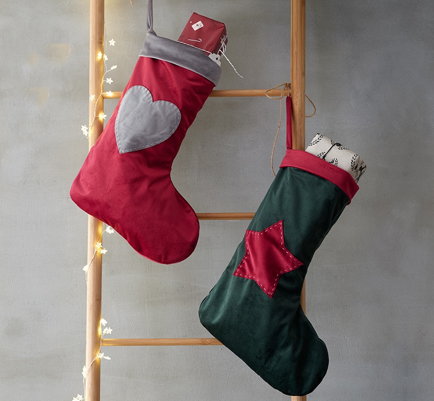 Christmas socks in red and green on a decorative ladder